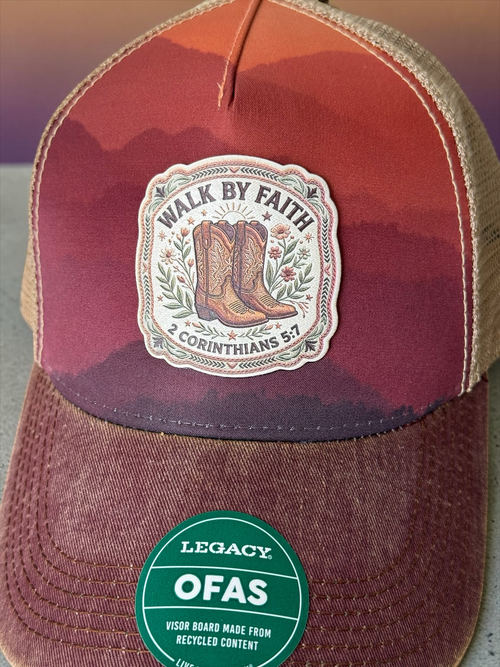 Moss & Maple Signs and Designs trucker hat with sunset mountain print, cowboy boot patch, and Walk by Faith text.